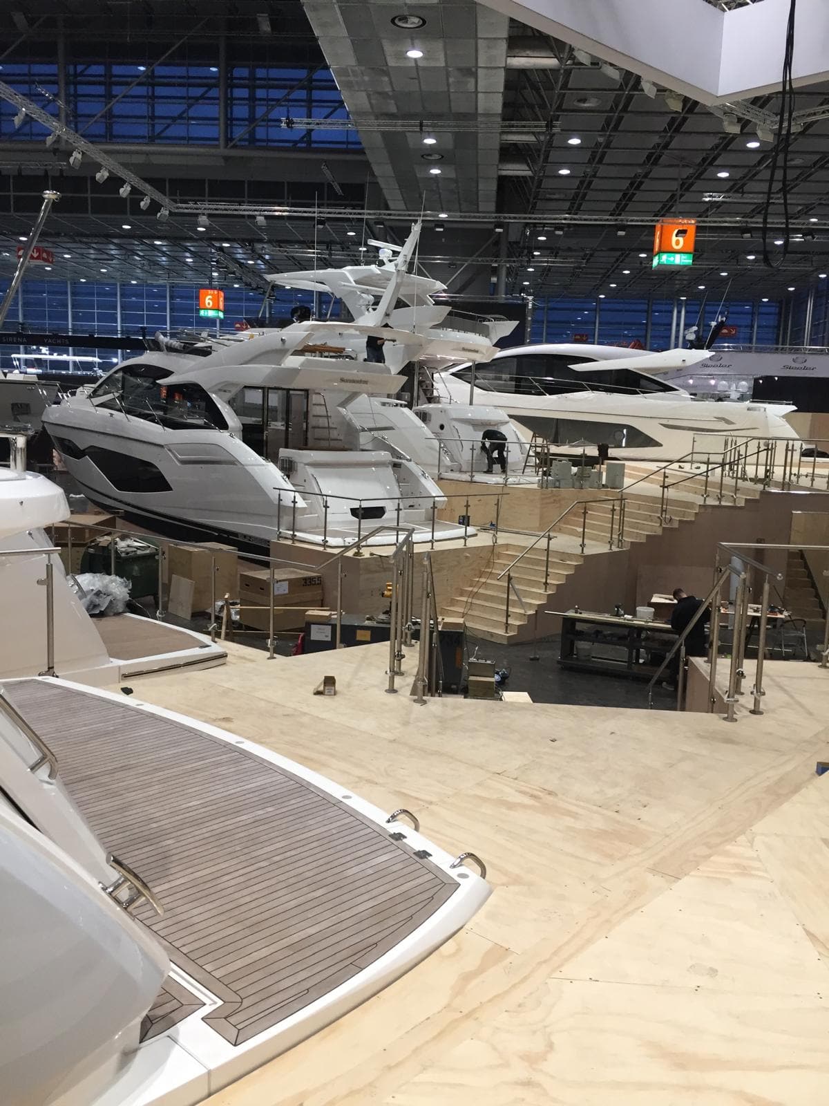 Row of motor yachts alongside the finished plywood display decking