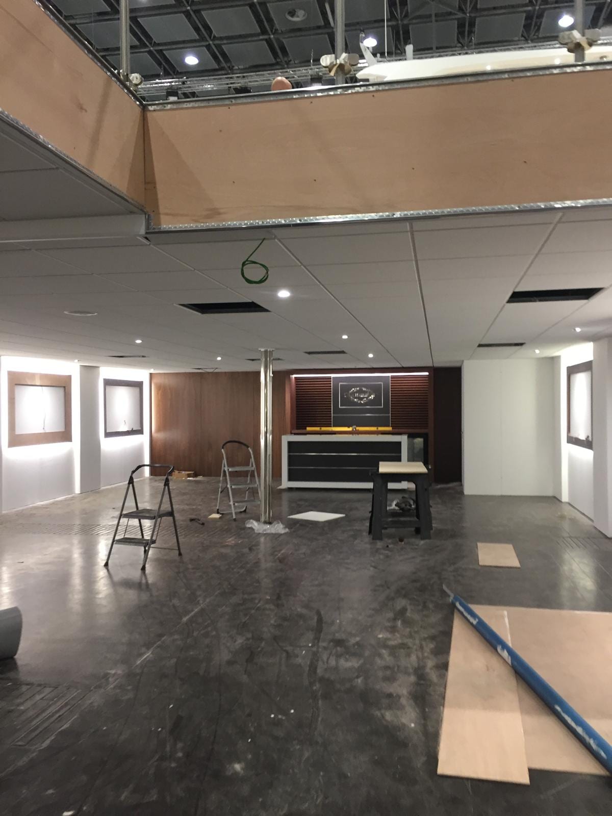 Hospitality room on the stand with dark timber panelling and recessed lighting