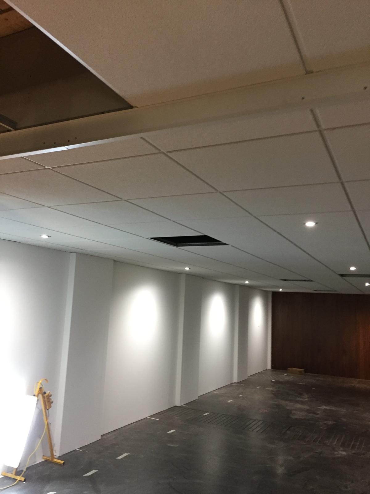Finished corridor on the stand with plastered walls and downlights