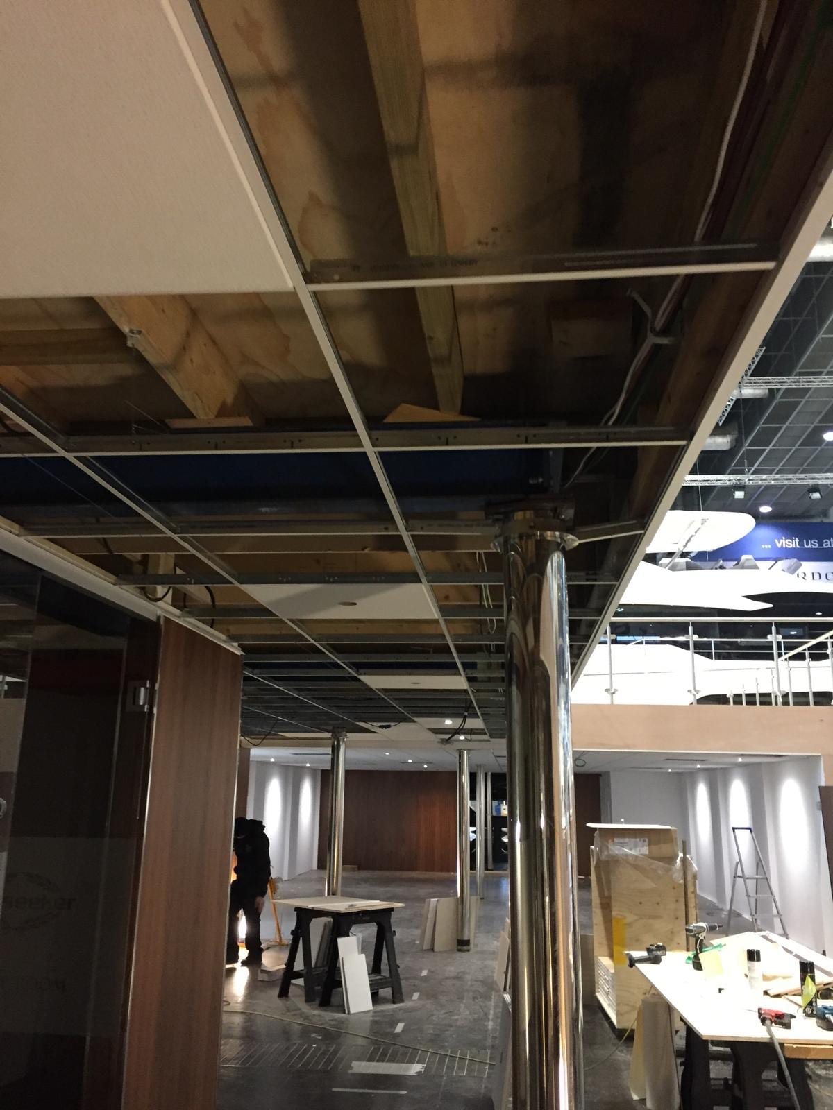 Suspended ceiling grid being set out above the stand floor
