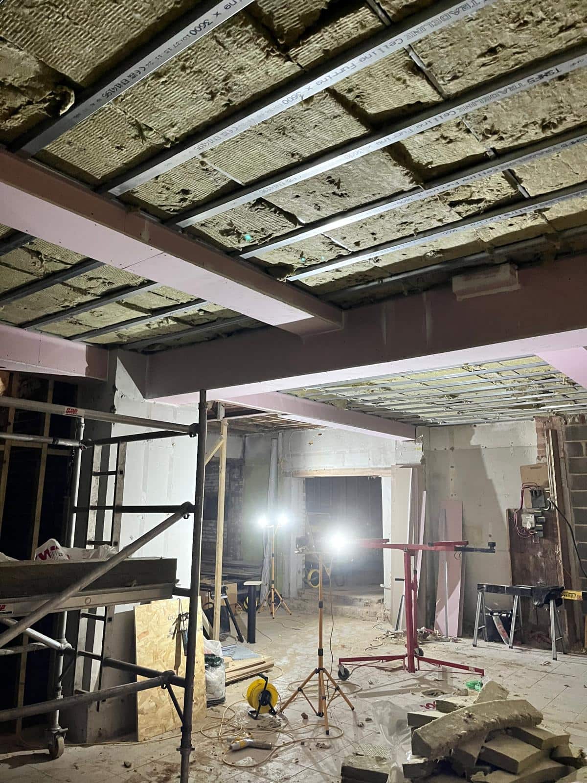 Scaffold tower and task lighting in the stripped shop unit during the ceiling works