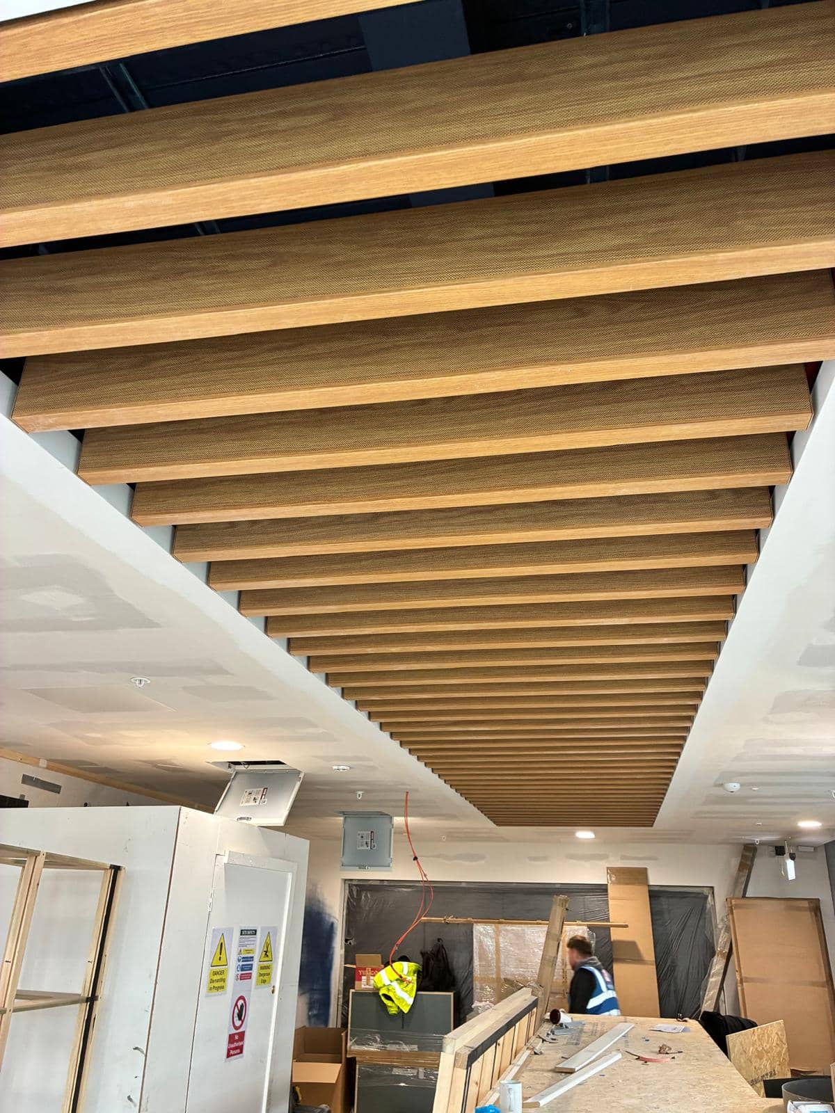 Timber baffle ceiling running the width of the floor above the counter