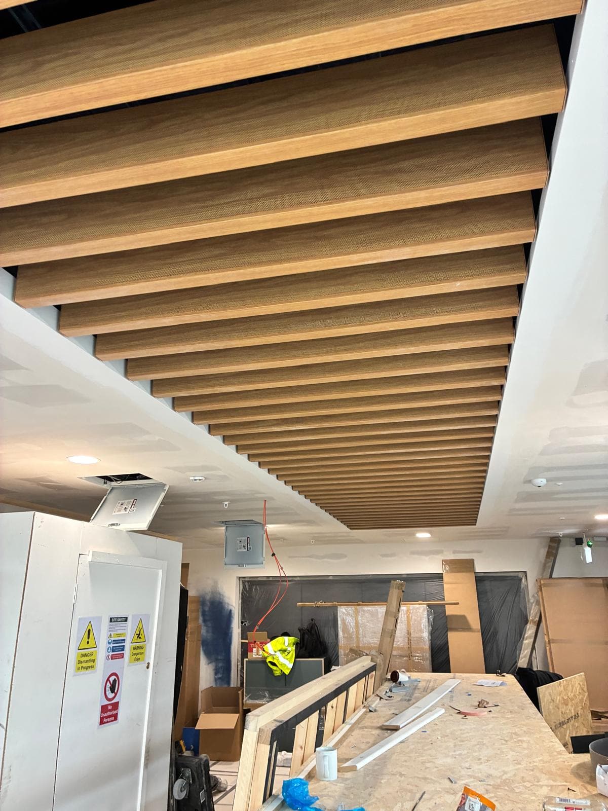 Timber baffle ceiling and plastered bulkhead above the servery