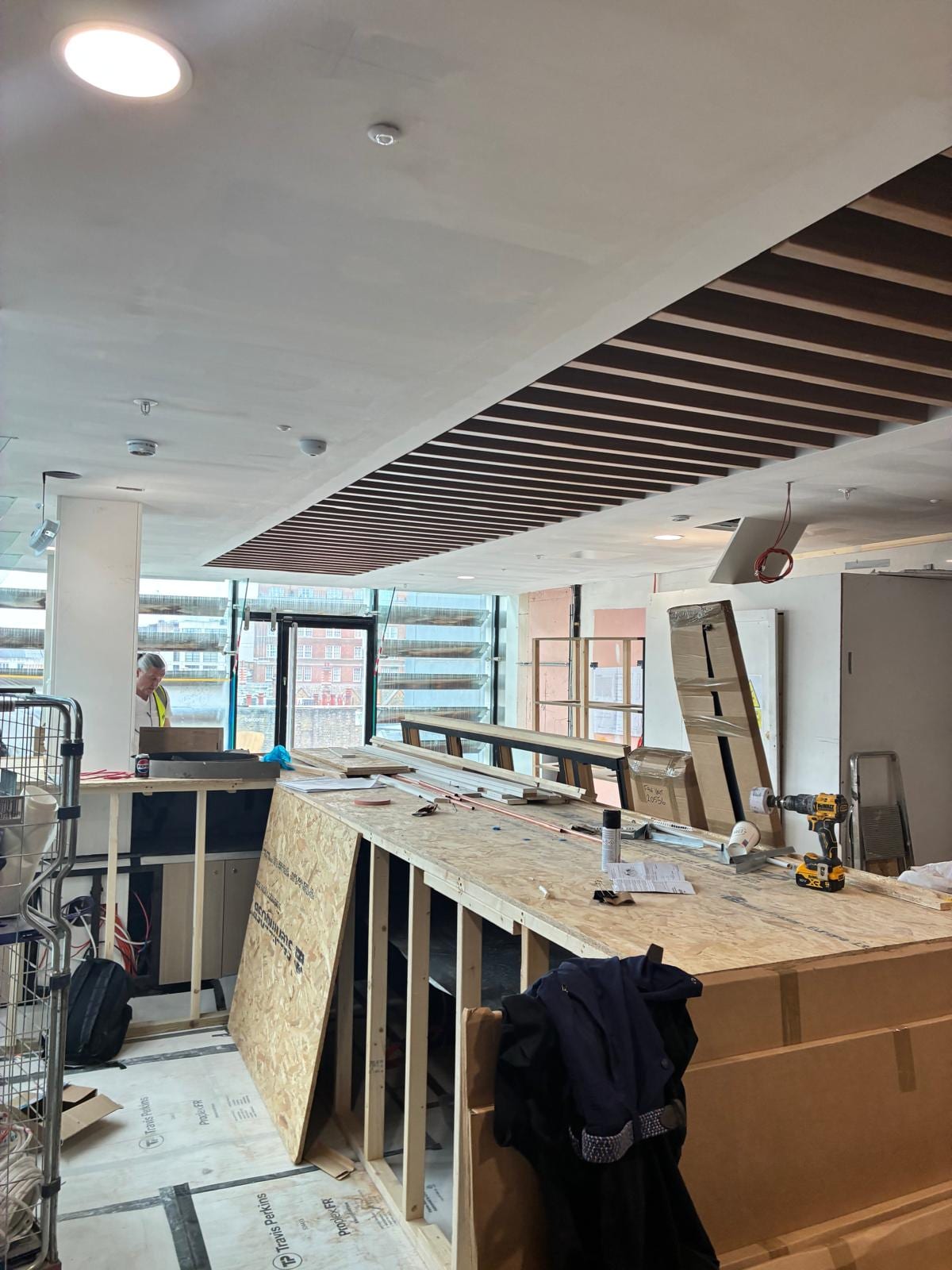 Timber baffle ceiling above the counter with materials stacked ready