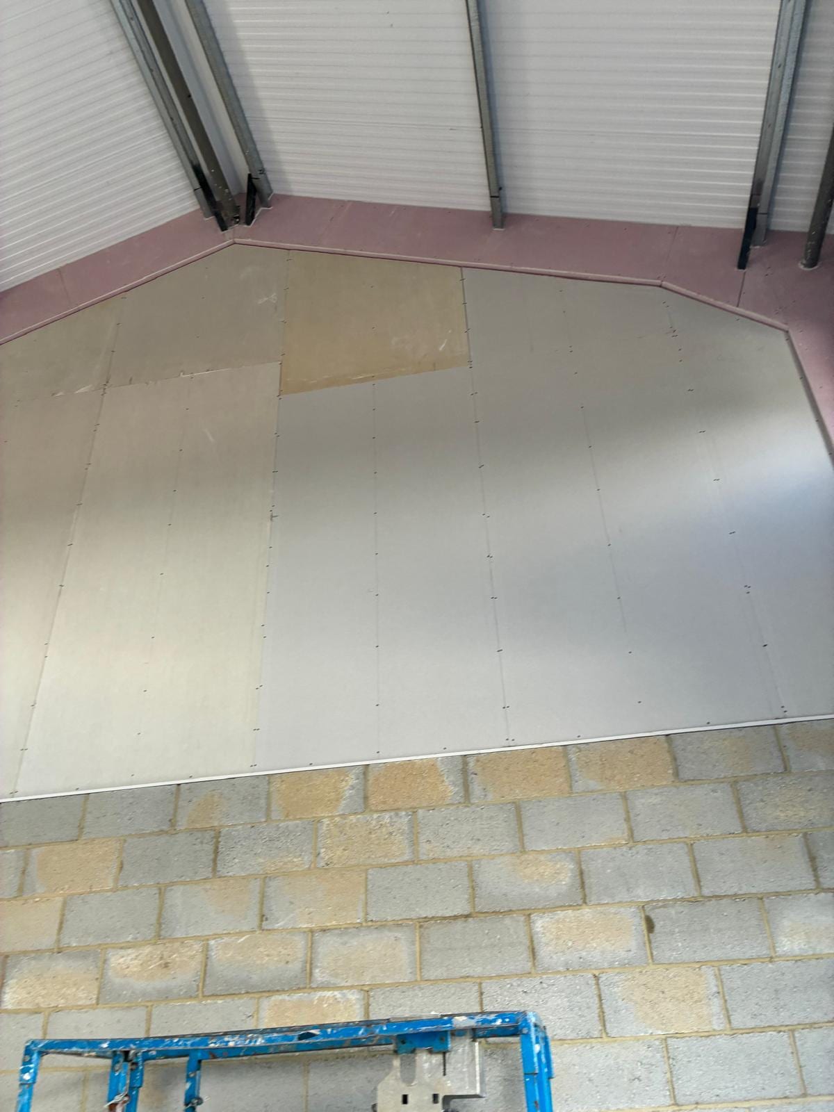 Curved plasterboard bulkhead formed above the stone wall finish