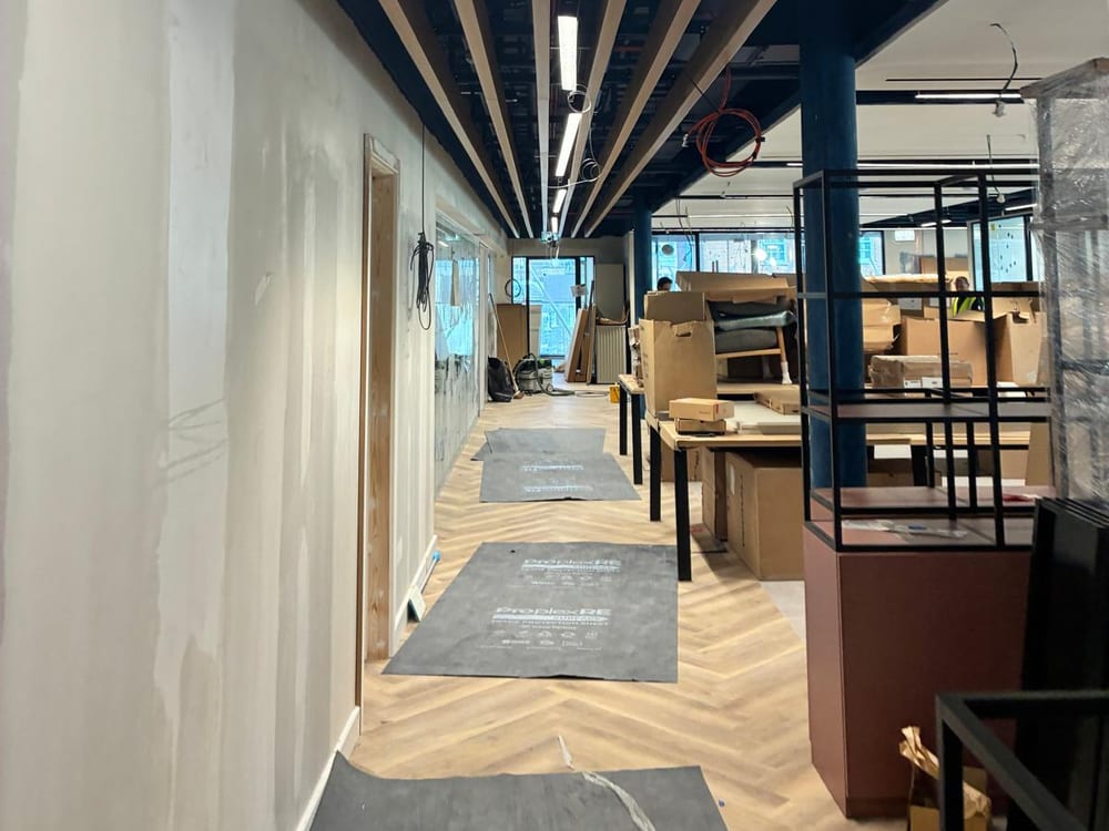 Timber baffle ceiling and dark painted soffit above a herringbone floor