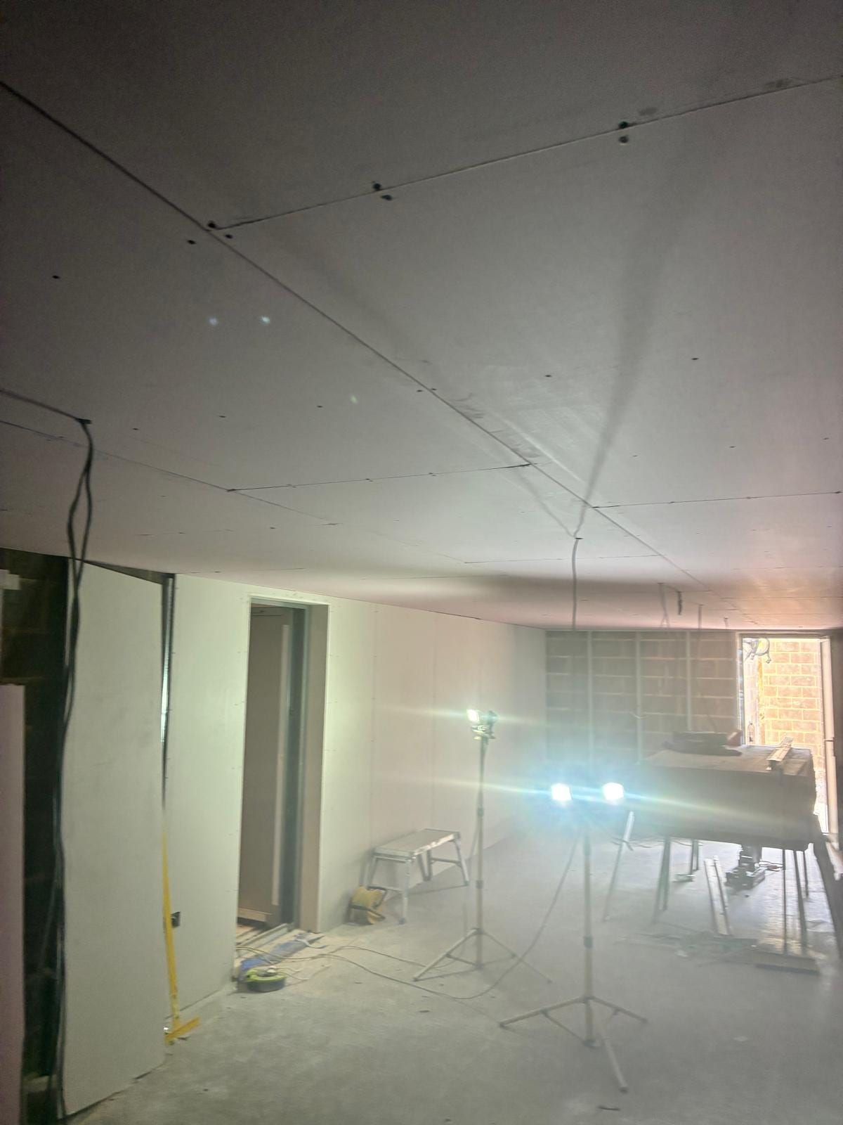 Finished plasterboard ceiling and stud partitions in the new room