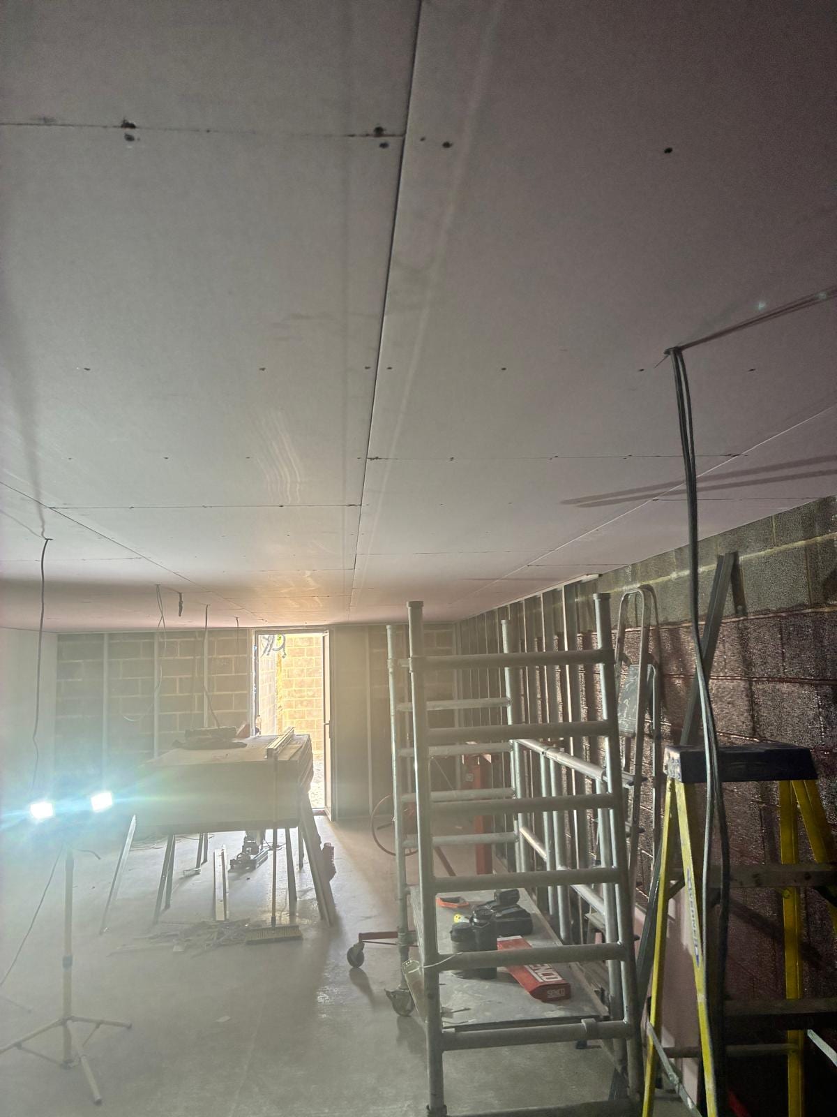 Plasterboard ceiling and blockwork walls lit by task lighting